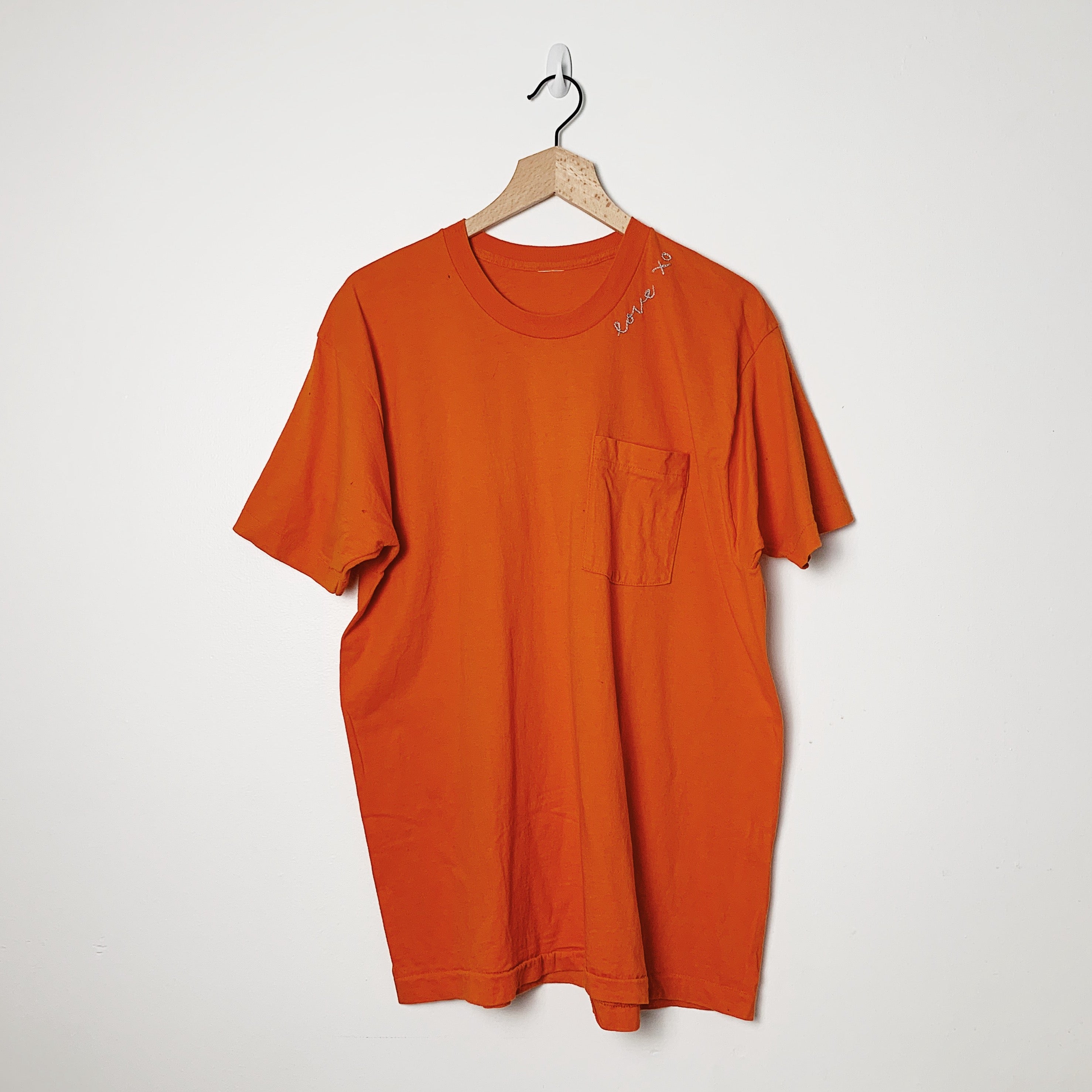Vintage tee with hand embroidered Love XO graphic at neckline, orange color.